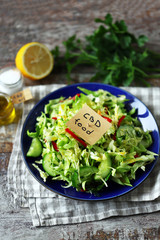 Selective focus. A note with the words cbd food in a plate with vegetable salad. Salad with the addition of CBD oil. Salad with fresh cabbage, herbs and cucumber. Vegan diet. Eco food. Cbd food.