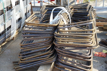 metal wires for construction or building with a layer of rust, stapled in two piles bound together in the deposit of construction material 