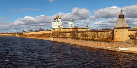 Spring panorama of an old medieval fortress standing on the river Bank. Pskov, Russia.