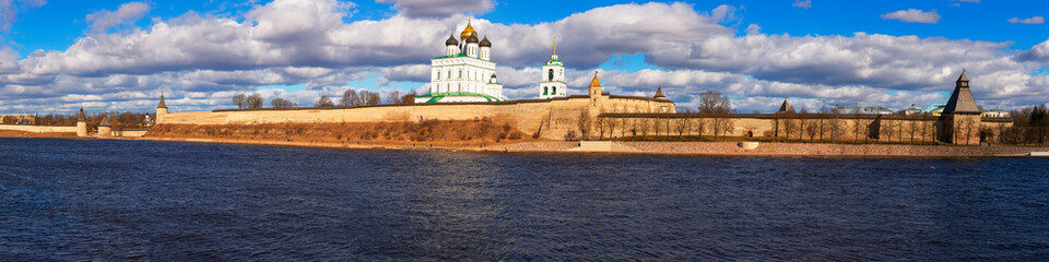 Spring panorama of an old medieval fortress standing on the river Bank. Pskov, Russia.