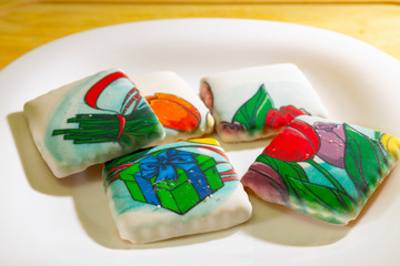 Cookies covered with icing are on the plate.