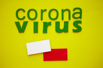 Flag of Poland And Word CORONAVIRUS made of green cardboard letters, isolated on yellow background. World Health Organization WHO introduced new official name for Coronavirus disease named COVID-19