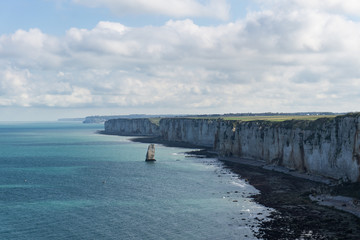 White chalk cliffs on the coast of the Atlantic Ocean and the English Channel. Scenic view of the coastline in Normandia in the town of Etretat in France. 
