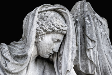 Woman crying at grave in cemetery