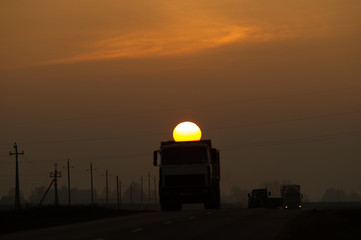 Fototapeta na wymiar the truck carries the sun with it