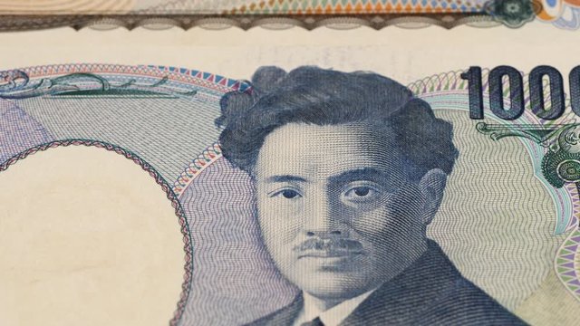 Japan yen notes fast tracking. Japanese money close up. Slider shot, macro. Low angle, 4K