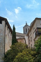 Fototapeta na wymiar Girona, Spain, August 2018. Medieval architecture on a background of blue cloudy sky.
