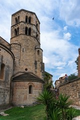 Fototapeta na wymiar Girona, Spain, August 2018. The tower of the monastery of St. Peter Galligans against a cloudy sky.