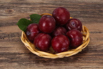 Plum heap in the wooden basket