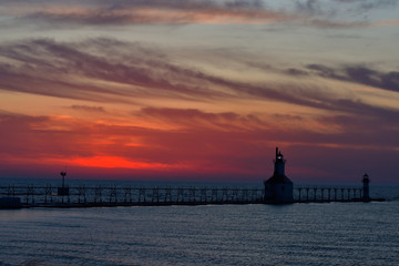 Sunset photo of the St Joseph Michigan North Pier Lighthouse and Lake Michigan taken from Tiscornia Park