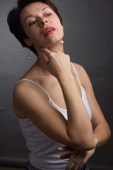 Fototapeta na wymiar brunette with short hair. Studio portrait in white t-shirt.