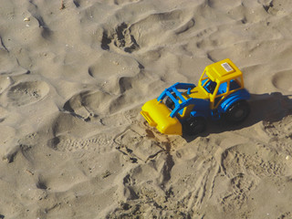 toy bulldozer on the beach