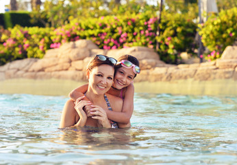 Portrait of mother with daughter on beach