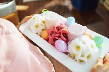 modern housewife holding easter decorated plate