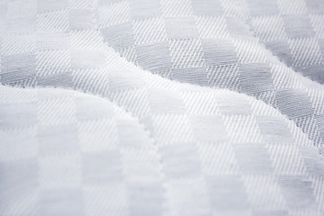 Natural jacquard mattress fabric with a pattern. Close-up photos.