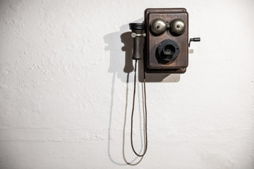 Vintage telephone on a white wall
