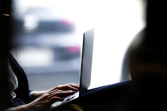 Business lady remotely working at a laptop close up