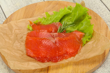 Sliced salmon fillet served rosemary