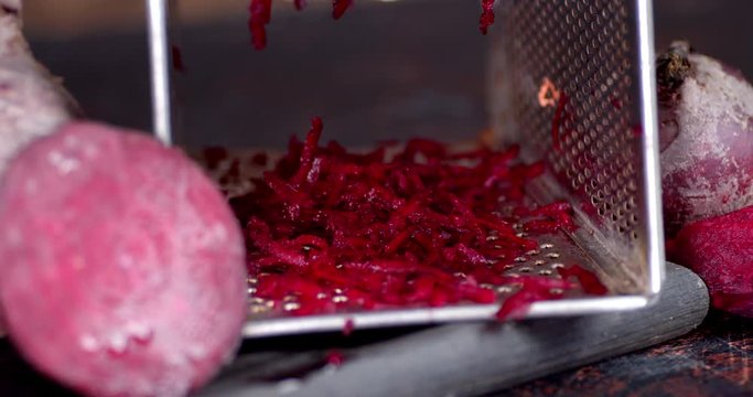 Rotating boiled beets with grater .