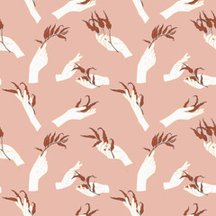 Abstract seamless pattern with female hands holding  branches with leaves. Delicate skin color, white, beige and terracotta.