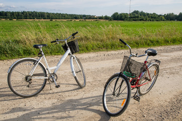 Naklejka na ściany i meble Two bicycles on a country road in summer. Photo taken in Jarvamaa, Estonia
