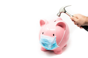 Piggybank wearing surgery mask; concept of the impact of a pandemia in Economy