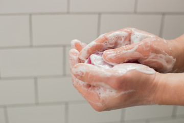 Fototapeta premium A man washing hands with soap. Preventing spreading virus concept.