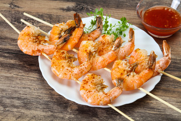 Grilled prawn skewer with sauce