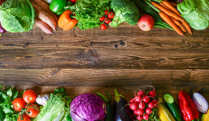 Vegetables on wood. Healthy various vegetable food, herbs and spices. Space for text.