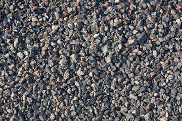 Fine crushed granite. The stone is gray with a splash of pink and red.