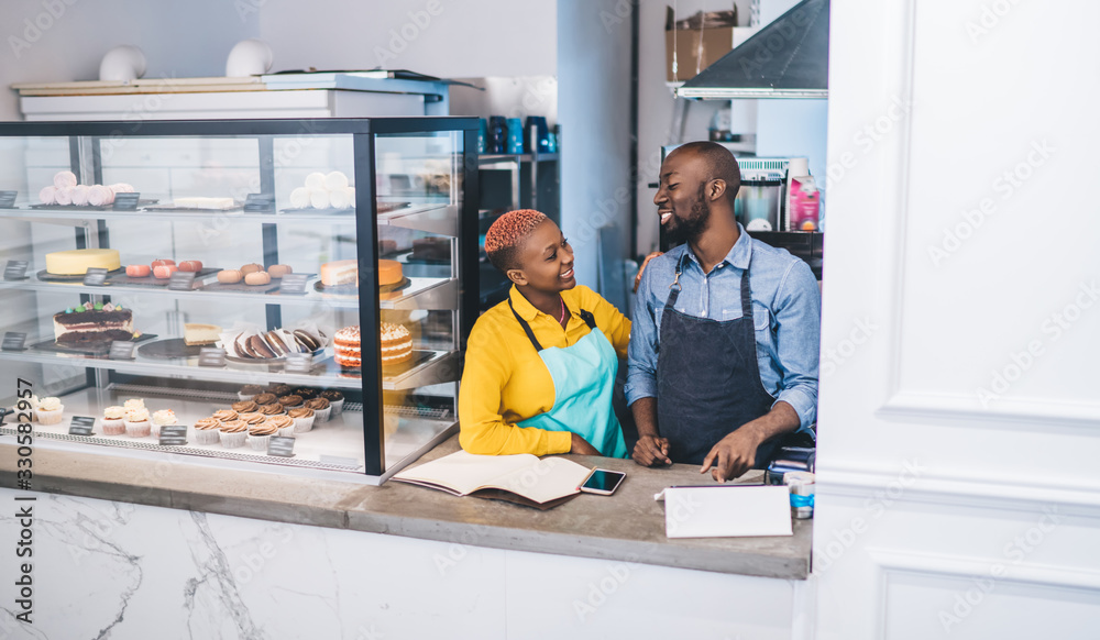 Canvas Prints Happy colleagues working together in pastry shop