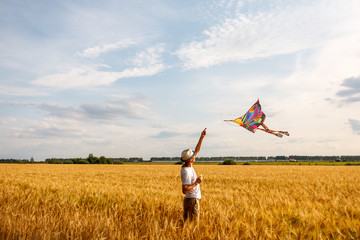 kite in hand against the blue sky in summer, flying kite launching, fun summer vacation, under the field, freedpm concept