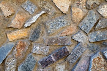 Texture of stones of different colors, bricks and concrete
