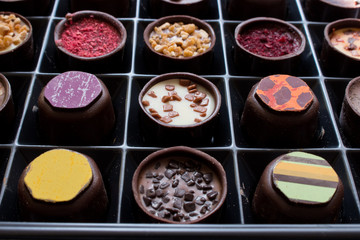 Various of sweet confectionery with chocolate candies and pralines. Handmade box of chocolates. Realistic chocolate set, delicious dessert pattern.