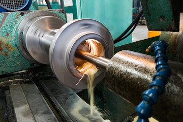 Internal grinding of a cylindrical mandrel with a water-cooled abrasive stone on a grinding machine.