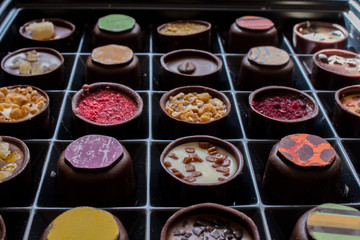 Various of sweet confectionery with chocolate candies and pralines. Handmade box of chocolates. Realistic chocolate set, delicious dessert pattern.