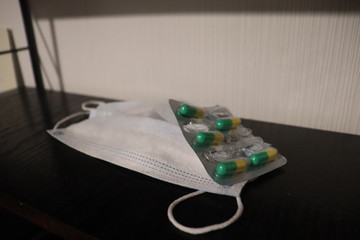 anti virus mask with pills on clinic table