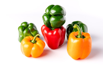 Varity of colored bell peppers on a white backdrop