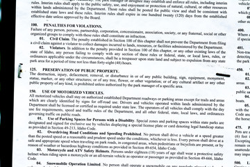 Naklejka premium Portion of warning sign stapled to a post in the Idaho forest