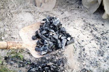 Man shovels coal from the ground