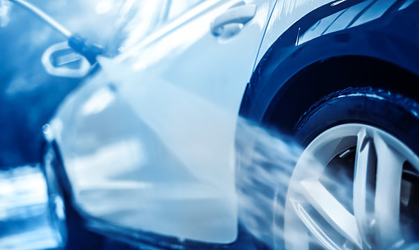 Car wheel wash. Car cleaning with water jet. Car rim or aloy washing close up.