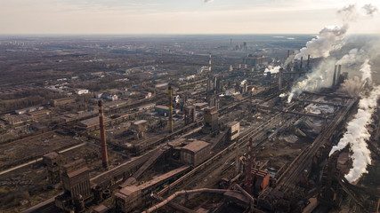 Steel ecology metallurgical iron plant smokes from pollution of industry pipes. View from the drone.