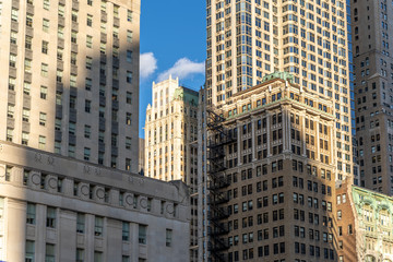 Fototapeta na wymiar Shadow of a modern skyscraper on historic buildings, new york city NYC manhattan