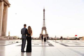 Happy couple looking on Eiffel tower, romantic date in Paris. Honeymoon in France