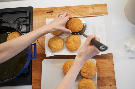 Placing Freshly Baked Doughnuts On Paper Towel