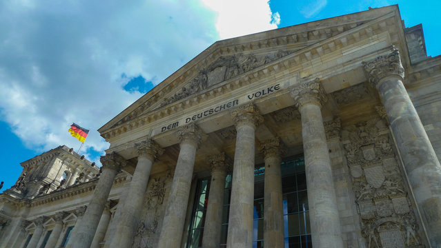 Reichstag parliament in Berlin / Germany with german flag