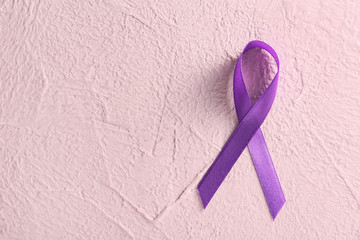 Violet ribbon on color background. Domestic violence concept
