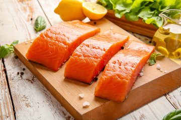 Raw salmon fillet on table