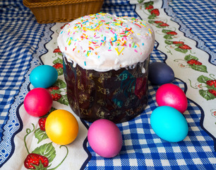 Brightly painted Easter eggs and Easter cake on the table
