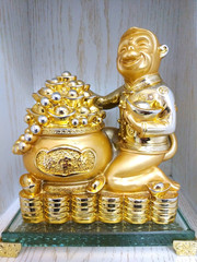 Statuette of a monkey with a bag of money and jewelry. figurine as a symbol of wealth and wealth and success